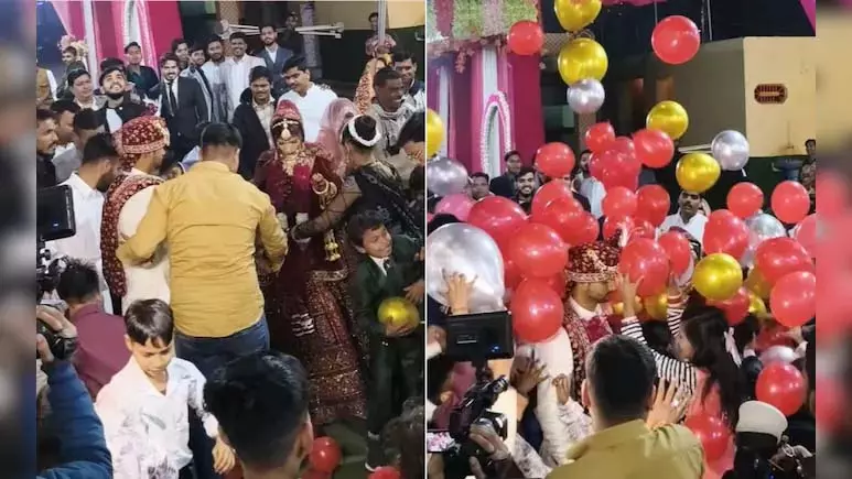 VIDEO: स्टेज पर दूल्हा-दुल्हन के एंट्री के समय ऊपर से गिरे गुब्बारे, फिर... VIDEO: स्टेज पर दूल्हा-दुल्हन के एंट्री के समय ऊपर से गिरे गुब्बारे, फिर...
