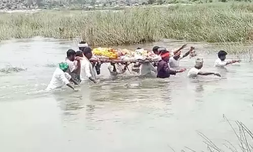 शव दफनाने के लिए संघर्ष; कब्रिस्तान तक पहुंचने के लिए तैरकर नदी पार करनी पड़ी शव दफनाने के लिए संघर्ष; कब्रिस्तान तक पहुंचने के लिए तैरकर नदी पार करनी पड़ी