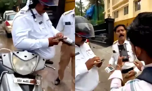 हेलमेट और नंबर प्लेट को लेकर बहस के बाद स्कूटर सवार और ट्रैफिक पुलिसकर्मी पर जुर्माना लगाया