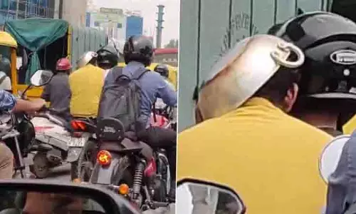 Bengaluru: चालान से बचने के लिए पीछे बैठे सवार ने सिर पर रखा फ्राइंग पैन